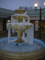 A frozen water fountain in an urban landscape.