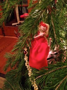 A girl playing the flute in a red dress.
