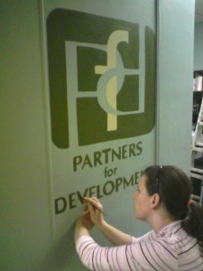 Painting the PFD logo on the wall.