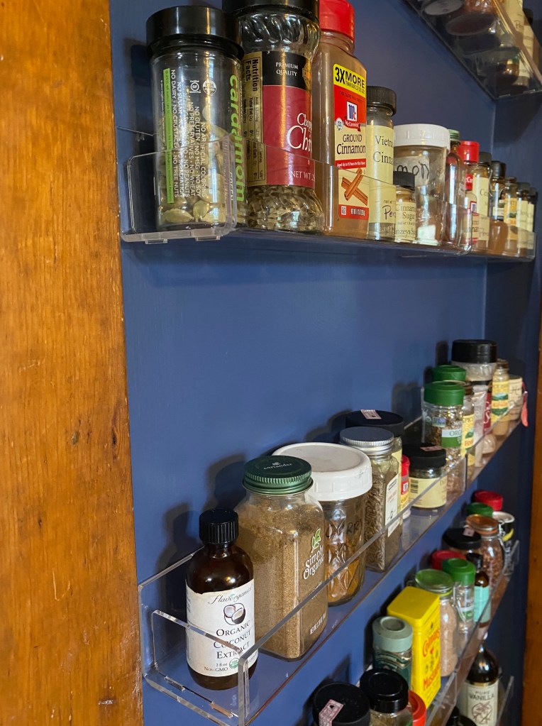 Close up view of the ghost shelves holding rows of spices.